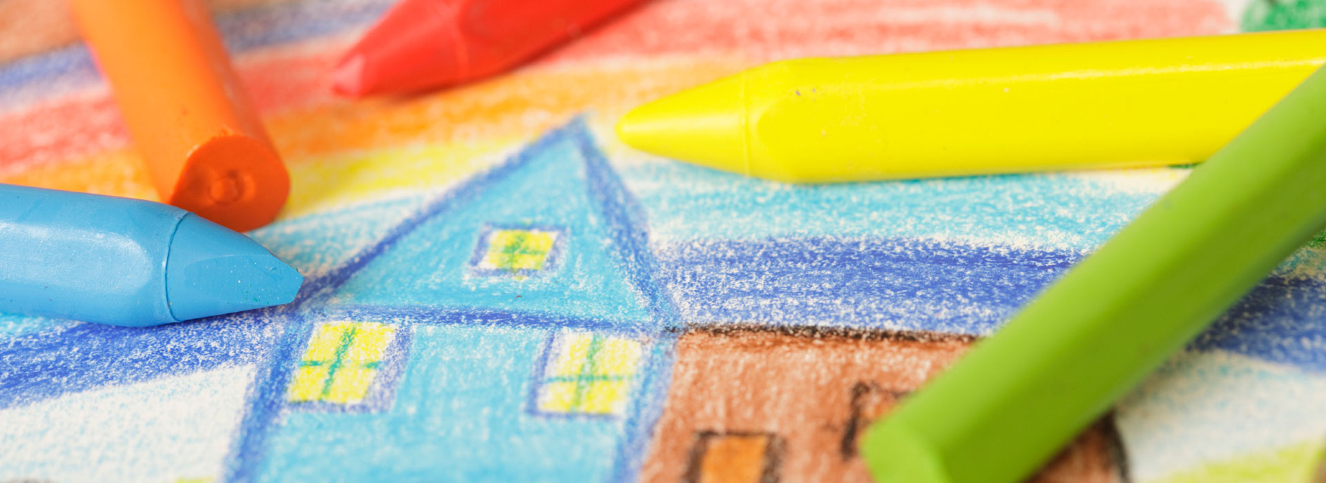 Crayons and drawing of a house
